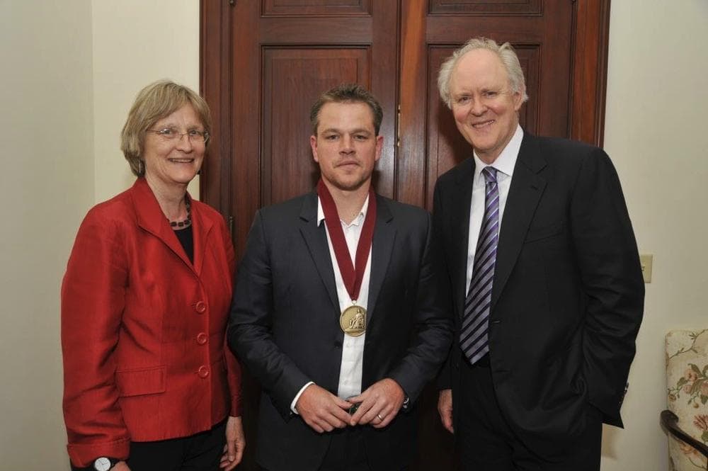 Matt Damon poses with President Drew G. Faust and John Lithgow, wearing his Harvard Arts medal, at Loeb House. (Jon Chase/Harvard Staff photographer)