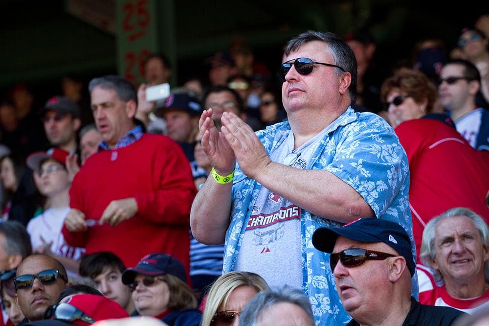 A fan claps for the beginning of a new Red Sox season. (Jesse Costa/WBUR)