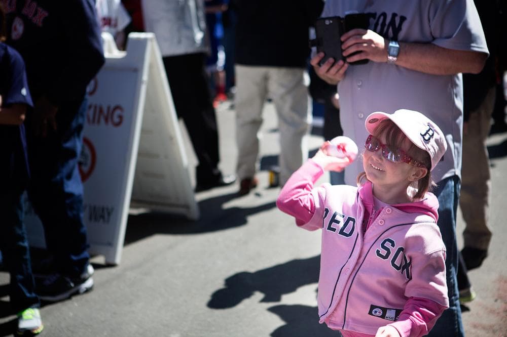 Teagan Sparhawk, 5 of Wakefield throws a ball during a game of catch on Yawkey Way before the game. (Jesse Costa/WBUR)