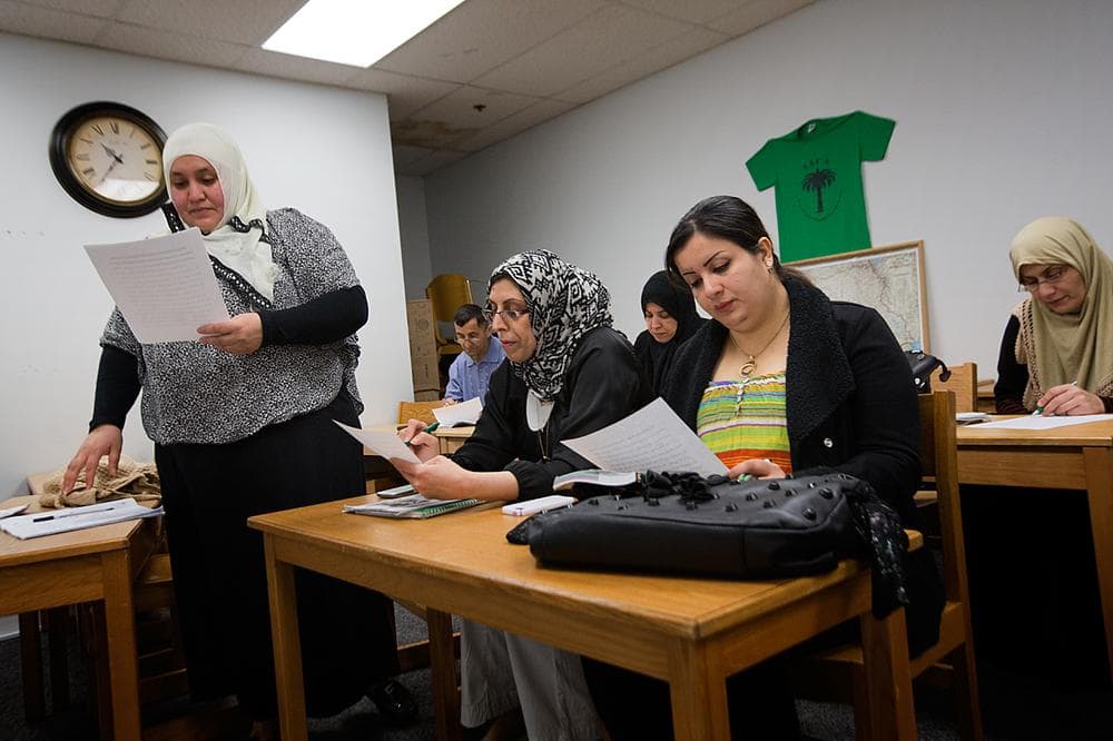 An ESL class reads English phrases at the Iraqi and Arab Community Association In Lynn. (Jesse Costa/WBUR)