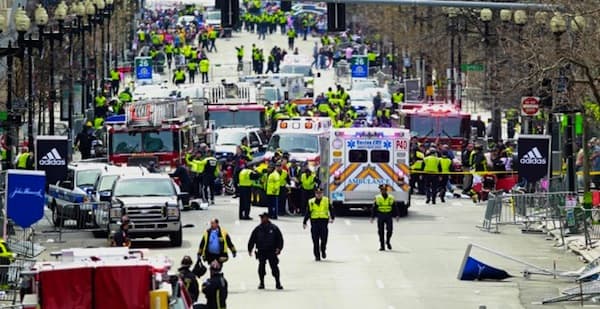 Police clear the area at the finish line of the 2013 Boston Marathon as medical workers help injured following the explosions. (Charles Krupa/AP)