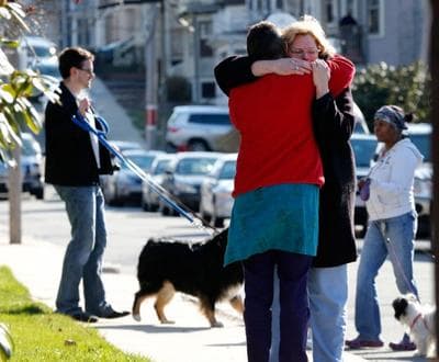 Neighbors hug outside the home of the Richard family in the Dorchester neighborhood of Boston, Tuesday, April 16, 2013. Martin Richard, 8, was killed in Mondays bombing at the finish line of the Boston Marathon. (AP Photo/Michael Dwyer)