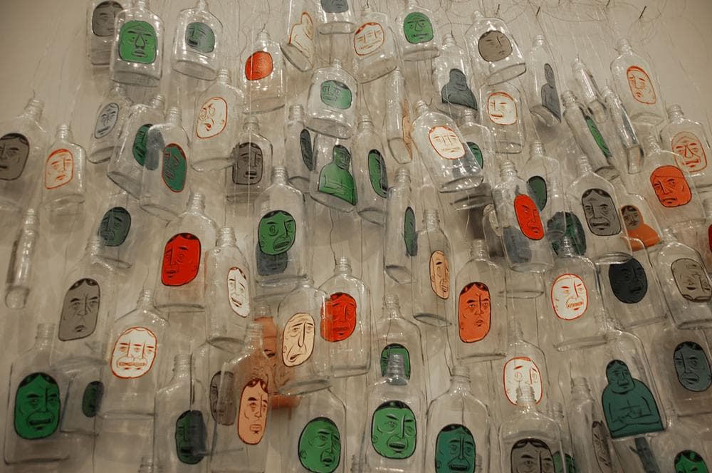 Barry McGee painted faces on booze bottles for this 1999-2005/2012 installation. (Greg Cook)