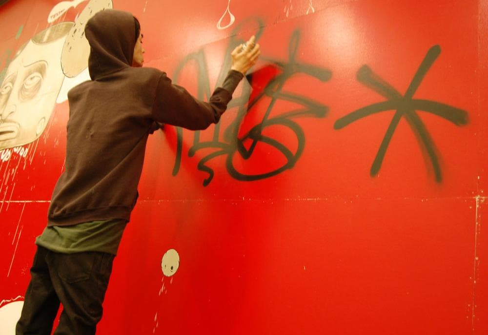 A robot mannequin depicts Barry McGee’s longtime collaborator Josh Lazcano tagging “Amaze” on the ICA's wall. (Greg Cook)
