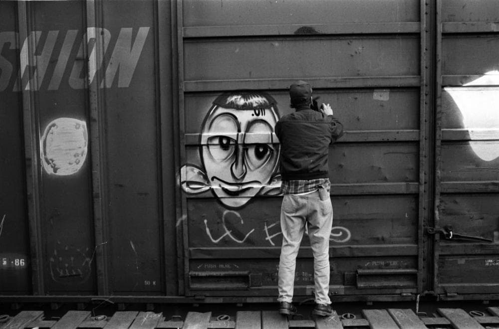 Barry McGee tagging in a train yard in 1993 (Craig Costello/Courtesy ICA)