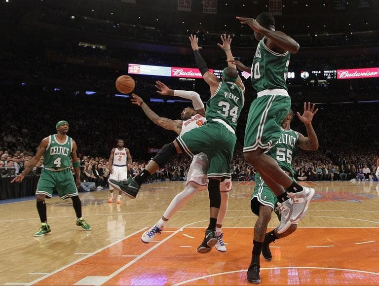 Celtics forwards Paul Pierce (34) and Brandon Bass (30) defend as New York Knicks guard J.R. Smith (8) tries to pass in the second half of Game 5. (AP/Kathy Willens)