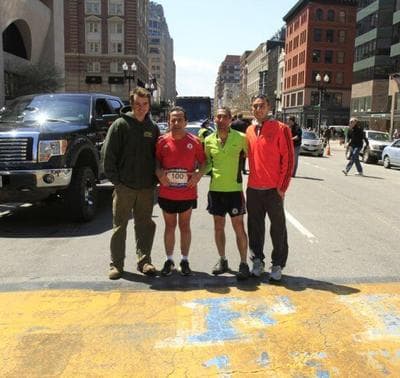Boston Marathon race director Dave McGillivray poses for a photo at the finish line with his friend and their sons, after running the course on Friday, April 27. (Courtesy Dave McGillivray )