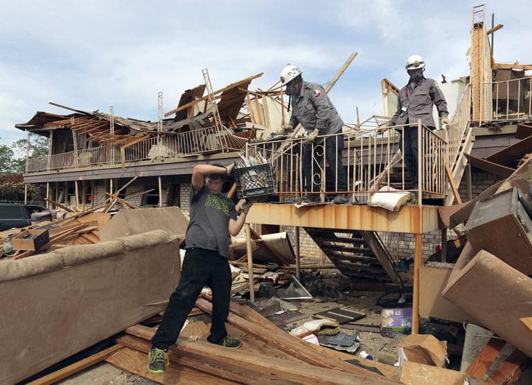 In this photo provided by the Texas Parks &amp; Wildlife Department, Lucas Lambert, left, removes belongings from his mother's residence in the apartment complex destroyed by a fertilizer plant explosion in West, Texas, Saturday, April 27, 2012. (Earl Nottingham/Texas Parks &amp; Wildlife Department via AP)