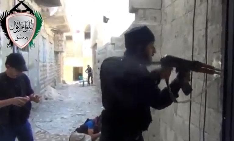 In this image taken from video obtained from the Ugarit News, which has been authenticated based on its contents and other AP reporting, Syrian rebels clash with government forces in Damascus, Syria, Friday, May 3, 2013. (Ugarit News via AP)