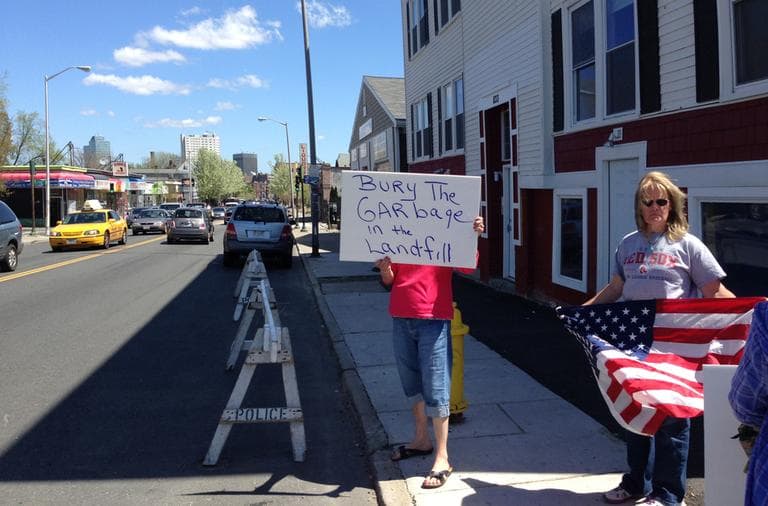 A protester holds a sign with &quot;Bury the garbage in the landfill,&quot; referring to the body of suspected Boston Marathon bomber Tamerlan Tsarnaev. (Deborah Becker/WBUR)