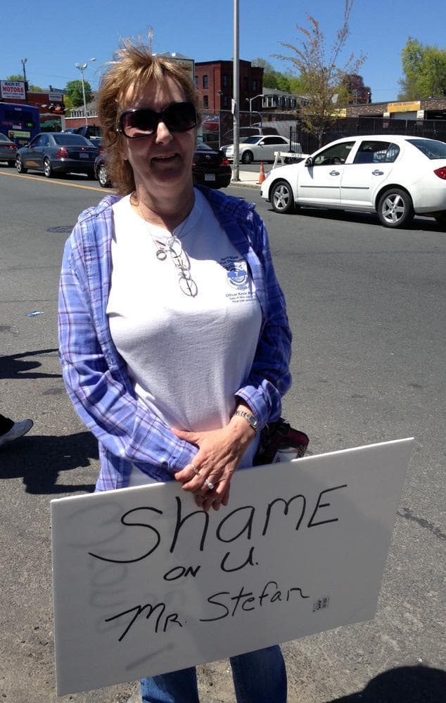 Pat Hildreth of New Hampshire protests, holding a sign that reads, &quot;Shame on u Mr. Stefan,&quot; referring to the director of the funeral home that has Tamerlan Tsarnaev's body. (Deborah Becker/WBUR)