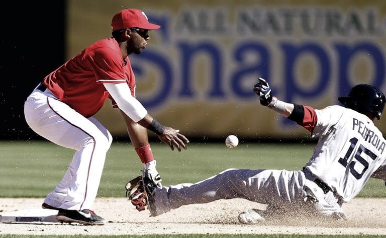 Red Sox's Dustin Pedroia (15) steals second base against Texas Rangers shortstop Elvis Andrus (1) during the eighth inning. (AP/LM Otero)