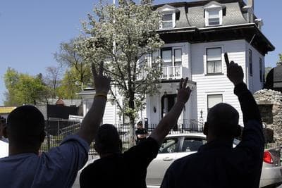 Protesters gesture outside the Graham, Putnam, and Mahoney Funeral Parlors in Worcester, Mass., Monday, where the body of killed Boston Marathon bombing suspect Tamerlan Tsarnaev is being prepared for burial. (AP)