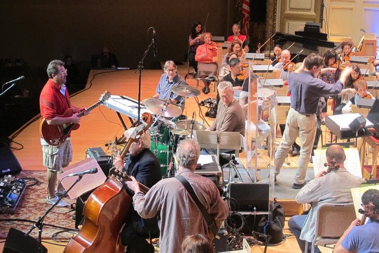 Vince Gill, left with guitar, rehearses with the Boston Pops Wednesday. (Andrea Shea/WBUR)