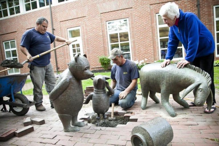 Sculptor Nancy Schön oversees the installation of Piglet at the Newton Public Library. (Courtesy of  Jacki Schon)