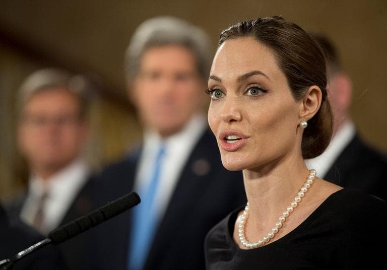 Flanked by G8 Foreign Ministers, U.S. actress Angelina Jolie, in her role as UN envoy, talks during a news conference regarding sexual violence against women in conflict, during the G8 Foreign Ministers meeting in London, Thursday, April, 11, 2013. (Alastair Grant/AP)