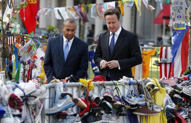 British Prime Minister David Cameron and Mass. Gov. Deval Patrick visit the makeshift memorial to the Boston Marathon bombing victims in Copley Square on Tuesday. (Michael Dwyer/AP)