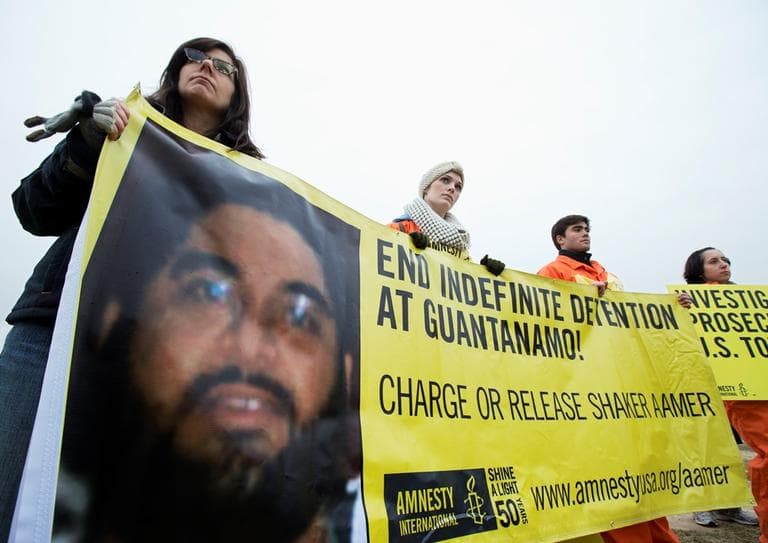 Human rights activists hold a banner with a picture of Saudi national Guantanamo detainee Shaker Aamer, during a rally near the White House in Washington, Friday, Jan. 11, 2013. (Manuel Balce Ceneta/AP)