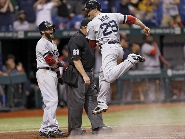 Red Sox's Daniel Nava (29) celebrates with Dustin Pedroia after scoring on a three-run double by Will Middlebrooks off Tampa Bay Rays relief pitcher Fernando Rodney. (AP/Chris O'Meara)