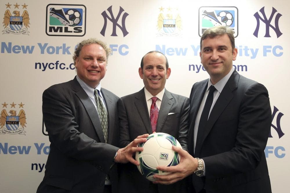 New York Yankees president Randy Levine, left, Major League Soccer Commissioner Don Garber, center, and Manchester City CEO Ferran Soriano pose for a photo at the MLS headquarter in New York, Tuesday, May 21, 2013. The New York Yankees are partnering with Manchester City to own Major League Soccer's 20th team, which will be called New York City Football Club and plans to start play in the 2015 season. (Mary Altaffer/AP)