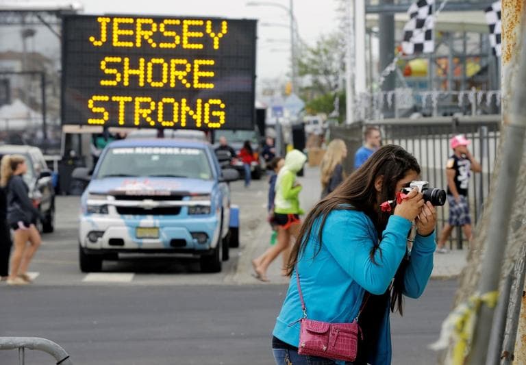 Angelina Zuzuro, 16, of Denville, takes photos near a sign in Seaside Heights, N.J., Saturday, May 18, 2013. (Mel Evans/AP)