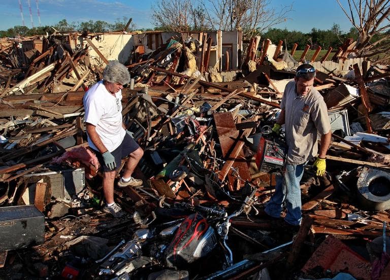 Chad Brown, right, helps his father Rick sift through the wreckage of his home in a neighborhood which was destroyed Monday when a tornado moved through Moore, Okla., Wednesday, May 22, 2013. (Brennan Linsley/AP)