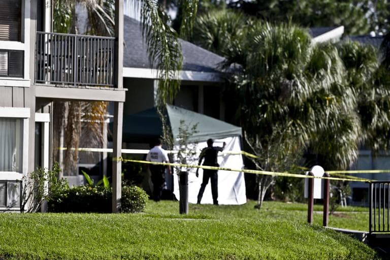 Investigators stand outside an apartment complex in Orlando, Fla., where on Wednesday a man being questioned by authorities in the Boston bombing probe was fatally shot when he initiated a violent confrontation, FBI officials said. (John Raoux/AP)