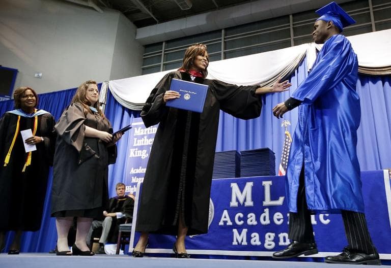 First lady Michelle Obama, second from right, hands out diplomas at the graduation ceremony for Martin Luther King, Jr. Academic Magnet High School on Saturday, May 18, 2013, in Nashville, Tenn. (Mark Humphrey/AP)