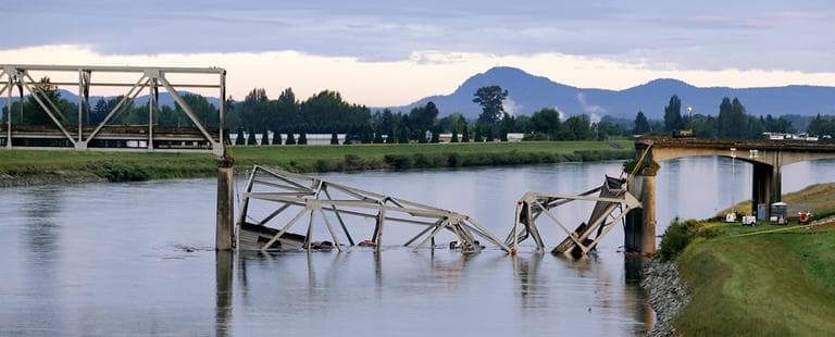 A collapsed portion of the Interstate 5 bridge lies in the Skagit River Friday, May 24, 2013, in Mount Vernon, Wash. (Elaine Thompson/AP)