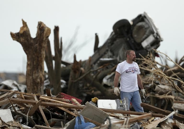 Bryan Taylor looks for items to salvage at his brother&#039;s tornado-ravaged home Saturday, May 25, 2013, in Moore, Okla. (Charlie Riedel/AP)