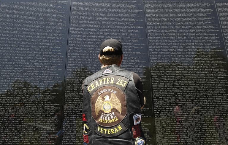 A veteran looks at the names of those who died etched into the wall of the Vietnam Veterans Memorial in Washington, Sunday, May 26, 2013. (Molly Riley/AP)