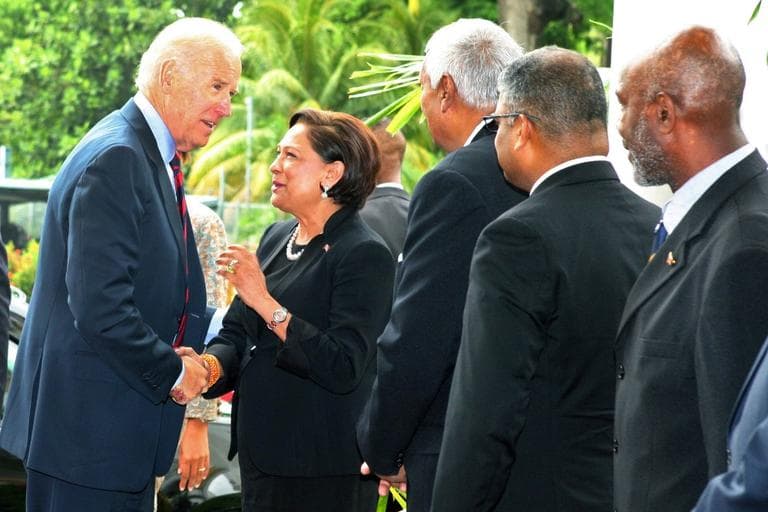 U.S. Vice President Joe Biden, left, is greeted by Trinidad &amp; Tobago's Prime Minister Kamla Persad-Bissessar and other officials upon his arrival to the Diplomatic Center in St. Anns, Trinidad, Tuesday, May 28, 2013. (Anthony Harris/AP)