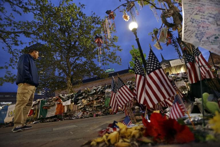 A man looks at a makeshift memorial at Copley Square in Boston almost one month after the bombings at the Boston Marathon finish line. (Elise Amendola/AP)