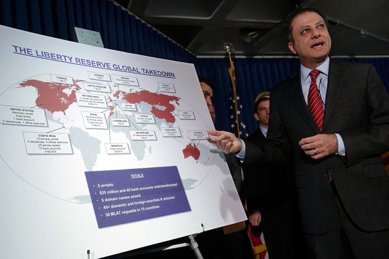 Preet Bharara, U.S. Attorney for the Southern District of New York, describes a chart showing the global interests of Liberty Reserve, during a news conference in New York, Tuesday, May 28, 2013. (Richard Drew/AP)