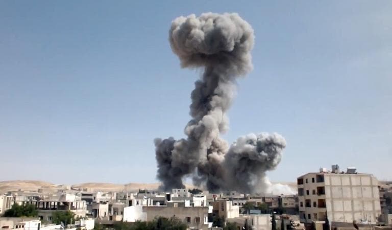 In this image taken from video obtained from the Shaam News Network, which has been authenticated based on its contents and other AP reporting, smoke rises after explosives were dropped by a Syrian government warplane in Yabroud near Damascus, Syria, Monday May 20, 2013. (Shaam News Network via AP)