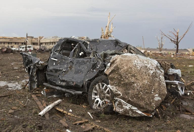A truck lays damaged in a field near the Moore Medical Center. (Alonzo Adams/ AP)