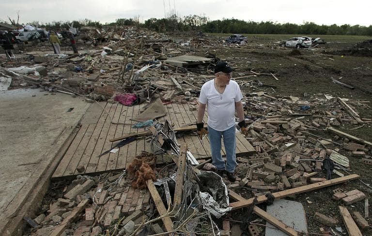 Donnie Bessinger looks through the rubble of his tornado-ravaged home Tuesday. (Charlie Riedel/ AP)
