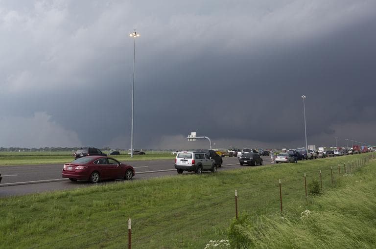 Traffic on Interstate 35 stops on Monday as the tornado ravages Moore, Okla. (AP Photo/Alonzo Adams)