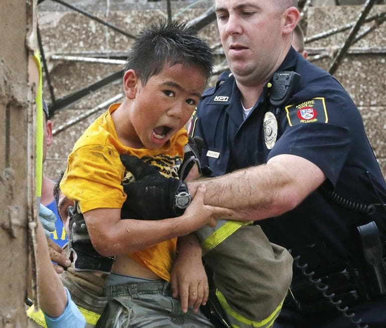 A boy is pulled from beneath a collapsed wall at the Plaza Towers Elementary School. (Sue Ogrocki/ AP)