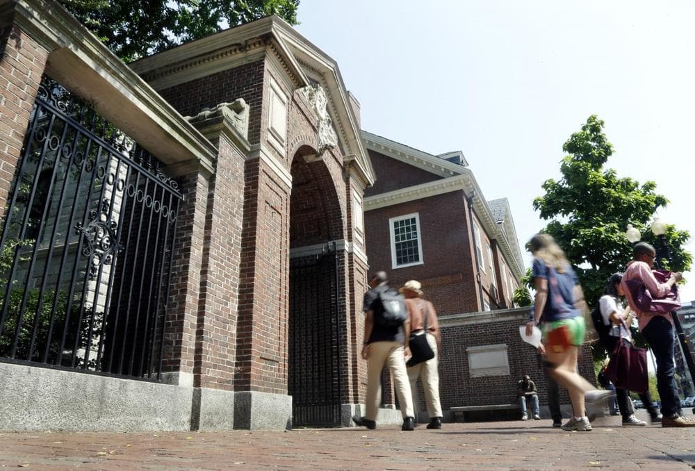 Pedestrians walk through a gate on the campus of HarvardUniversity in Cambridge, Mass. Thursday, Aug. 30, 2012. (AP)