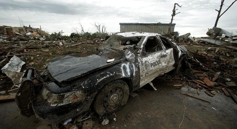 A destroyed police car sits among the debris of tornado-ravaged homes Tuesday, May 21, 2013, in Moore, Okla. (Charlie Riedel/ AP)