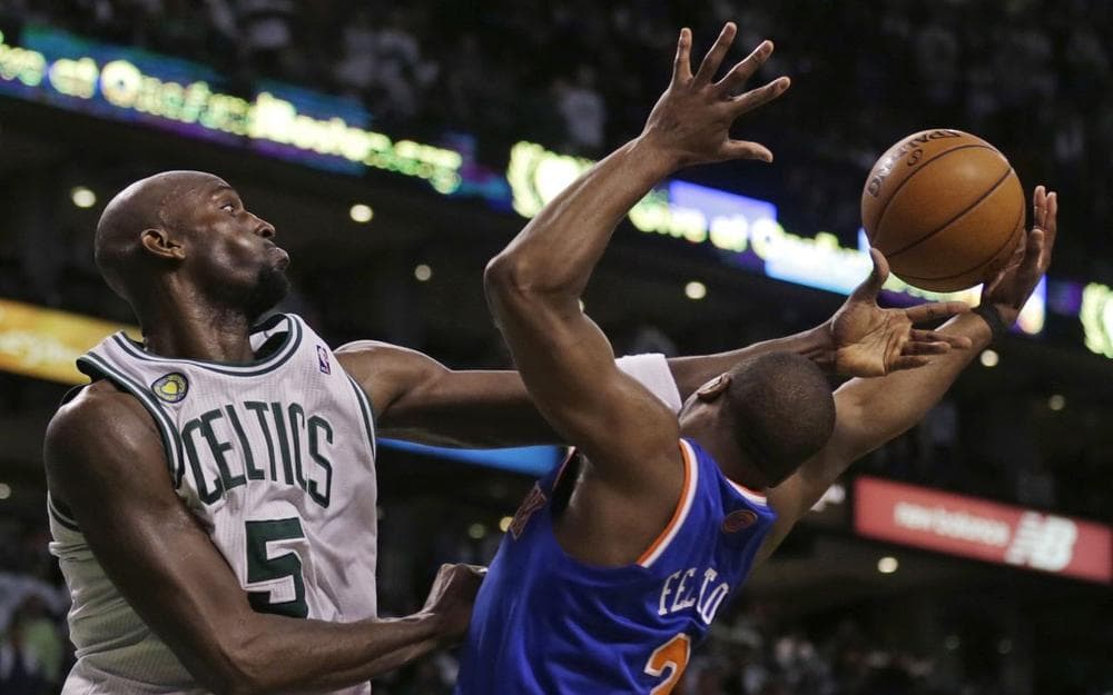Boston Celtics forward Kevin Garnett (5) reaches for a rebound over New York Knicks guard Raymond Felton (2) during the second half in Game 6 of their first-round NBA basketball playoff series in Boston, Friday, May 3, 2013. The Knicks won 88-80, eliminating the Celtics from the playoffs. (Charles Krupa/AP)