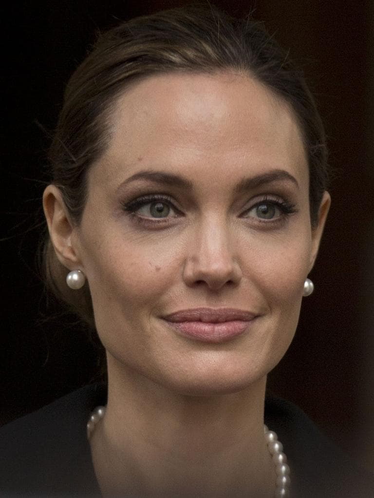 Angelina Jolie looks to the media as she leaves a G8 Foreign Ministers meeting on sexual violence against women in London, Thursday, April, 11, 2013. (AP)