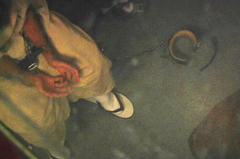 In this April 16, 2013 video frame grab reviewed by the U.S. military, a shackled detainee meets with medical personnel in Camp 6, at Guantanamo Bay Naval Base, in Cuba. (AP)