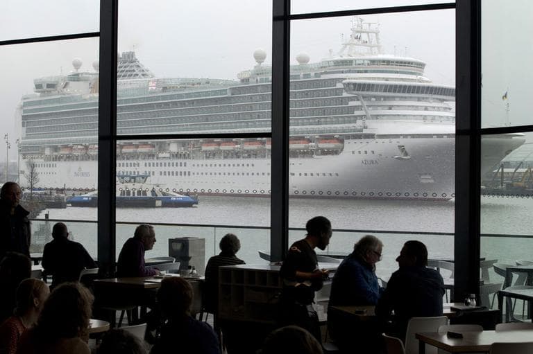 In this Jan. 9, 2013 file photo the Italian-built cruise ship MS Azura sails past the EYE film institute as it leaves the port of Amsterdam, Netherlands. (AP)