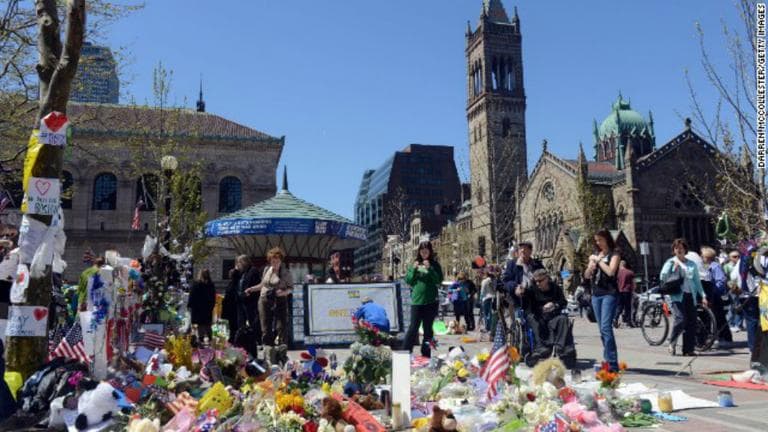 The impromptu memorial for the Boston Marathon bombings continues to grow in Copley Square, while tribute songs memorializing the bombing sprout up online. (Darren McCollester/Getty Images)
