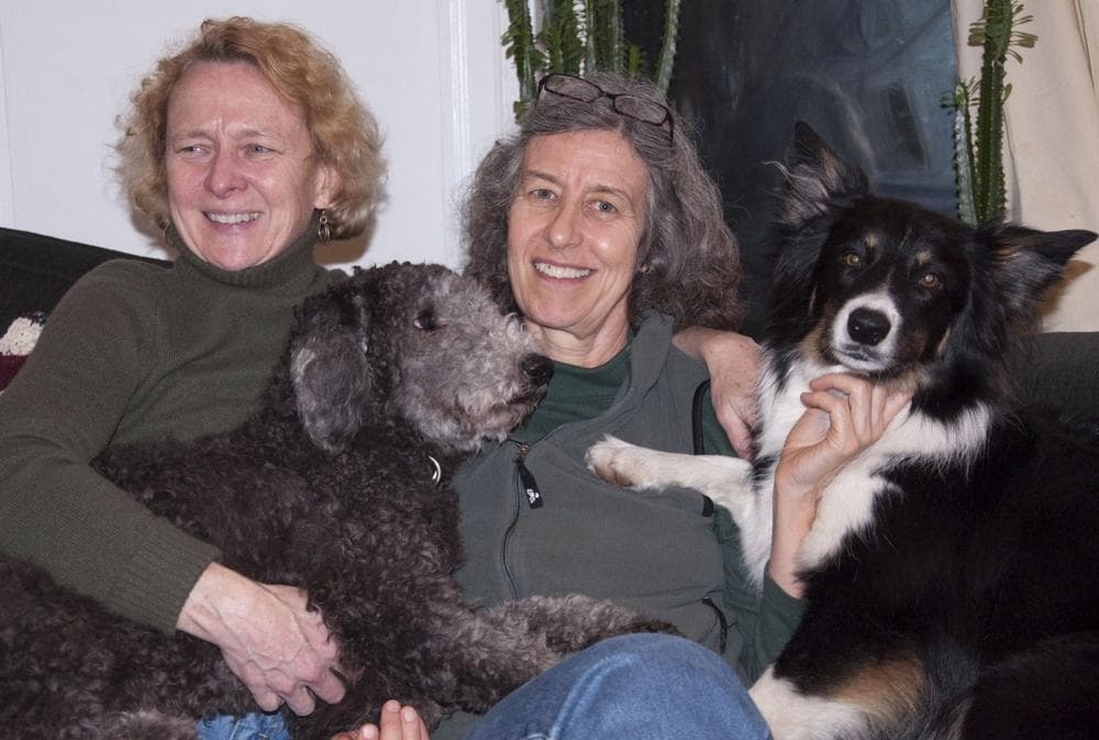 Lee Swislow (right) and her wife Denise at home with their border collie Strider, and their poodle, Bishop. (Courtesy)