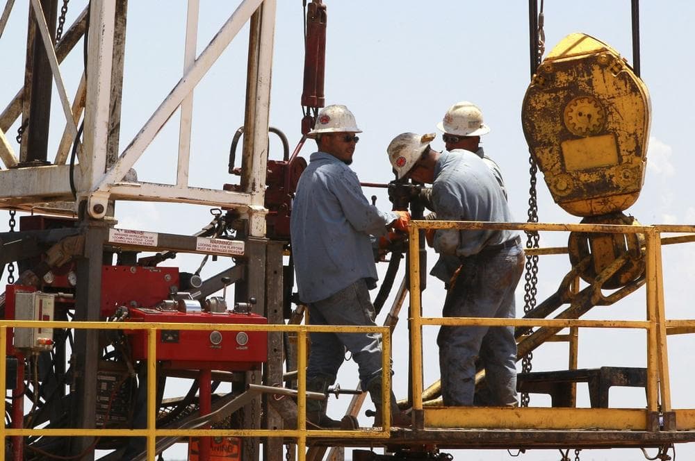 In this Friday, July 20, 2012 photo, workers are pictured on a drilling rig near Calumet, Okla. Oklahoma is one of several states, including North and South Dakota, that has enjoyed a boom in the energy sector driven in large part by new and improved drilling techniques such as horizontal drilling and hydraulic fracturing, which cracks open fissures in rock formations to retrieve oil and gas. (AP)