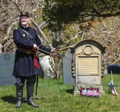 Dale Julius points out the grave of Francis Davis Millet, an East Bridgewater resident who drowned in the Titanic Disaster, 1912.  (Courtesy of Jim Weidenfeller)