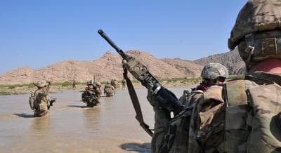 In this April 10, 2013 photo released by the U.S. Army, U.S. Soldiers with Charlie Company, 1st Battalion, 38th Infantry Regiment, 4th Brigade Combat Team, 2nd Infantry Division cross the Tarnak river in the Panjwai district of Kandahar province, Afghanistan on a two-day mission to clear the area of explosives caches. (Sgt. Kimberly Hackbarth, U.S. Army/AP)